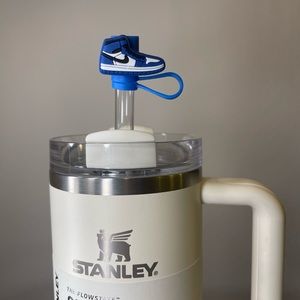 3 blue, 2 red, one pink and black Stanley topper